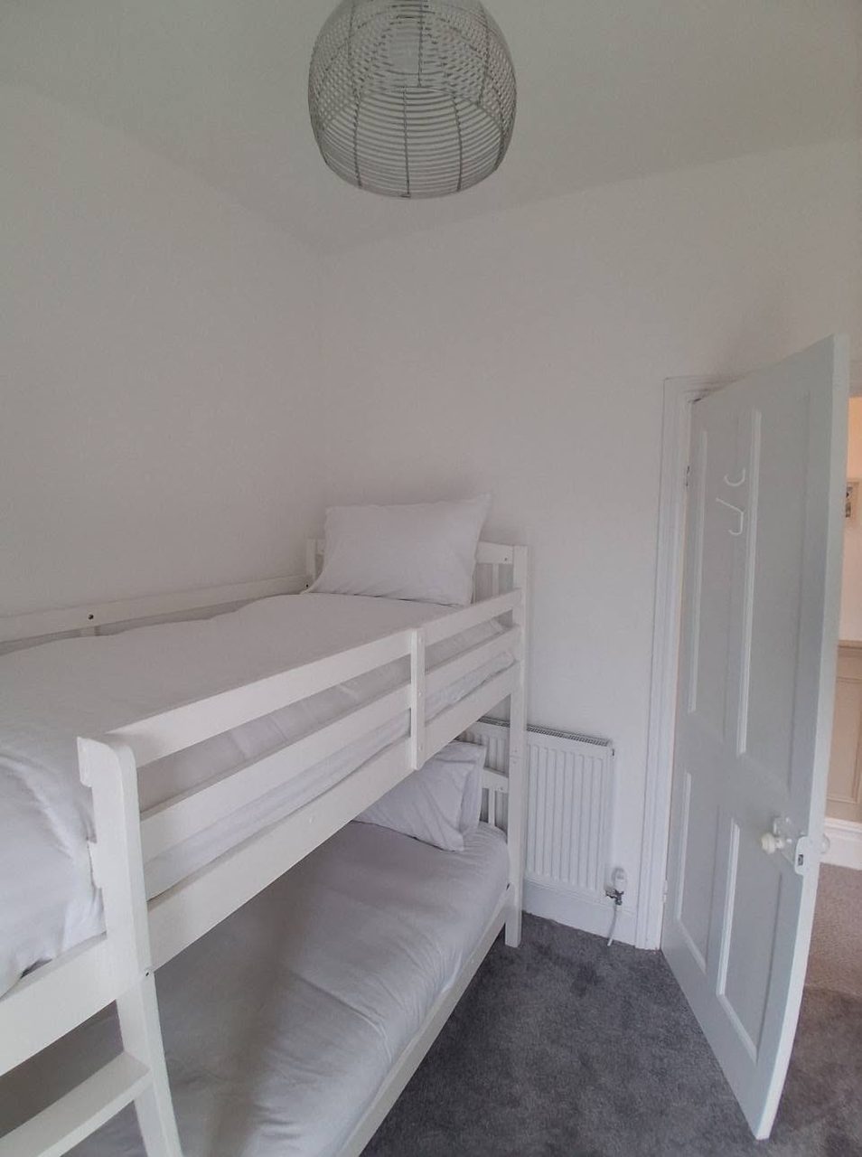 Crisp white bunk room for the little ones